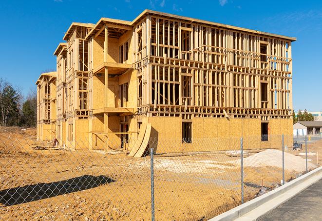 a temporary chain link fence winding around a construction site, outlining the project's progress in Menifee